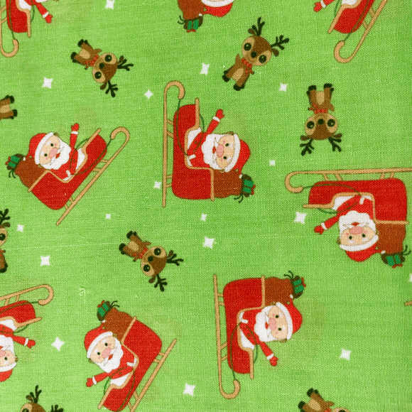 Fabric Xmas santa slider on lime green Spectacular Fabrics
